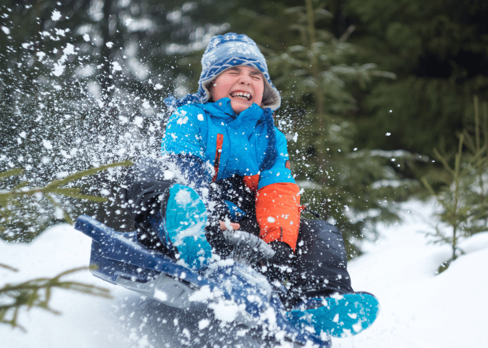 boy sledding joyful