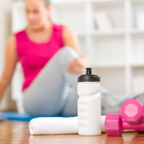picture of dumbells, water bottle, and woman stretching